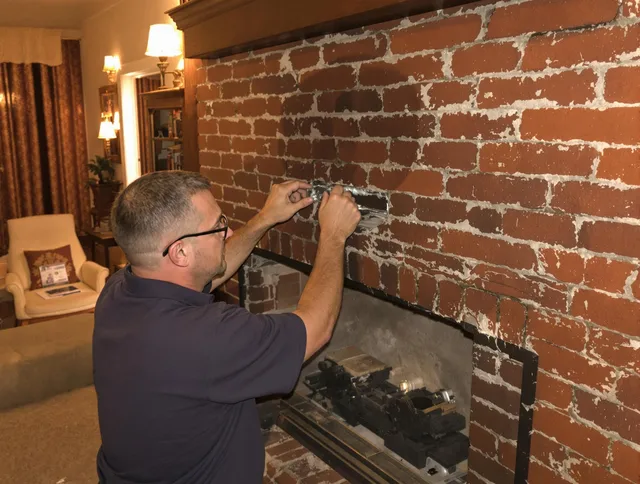 Cleveland Heights Chimney Sweep expert fixing a fireplace in Cleveland Heights, OH